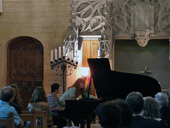 Sarah Cahill (standing) and Regina Schaffer performing a work by Terry Riley in the Chimes Chapel