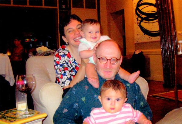 Kernis and his wife with their two young twins, one sitting on his lap, the other on his shoulders