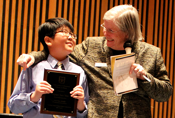 HyunJun (John) Yoo of West Middle School, Columbia, a multiple C.O.M.P. winner, with Jeanne Sinquefield Ph.D of the Sinquefield Charitable Foundation