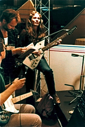 Laurie Spiegel playing an electric guitar