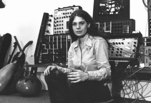 Spiegel sitting in front of synthesizers and a tamboura