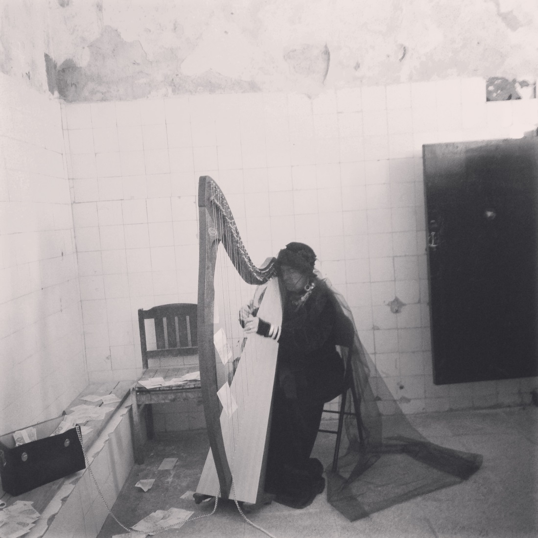 A musician performing on a traditional harp