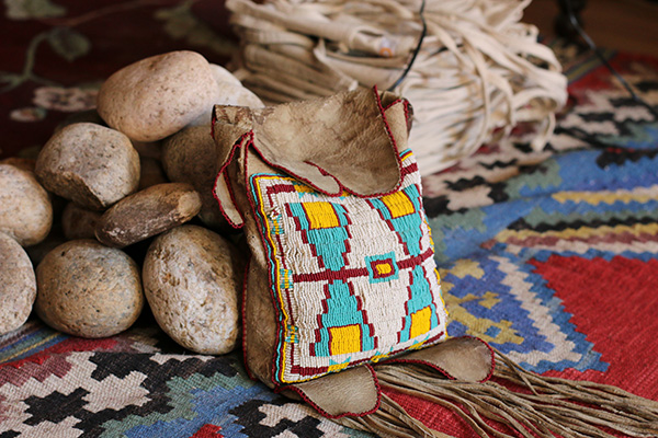 A group of rocks and a pouch on top of a native American rug