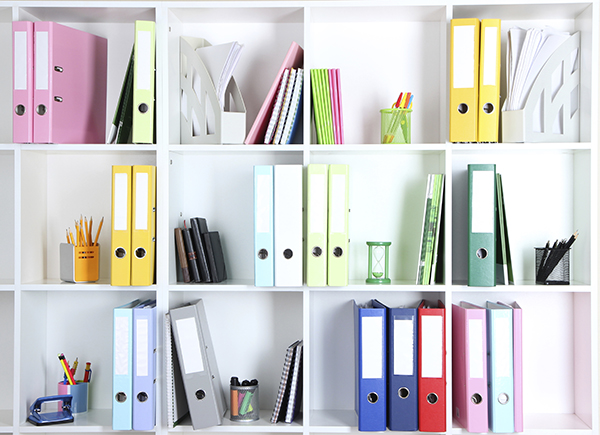 White office shelves with folders and different stationery, clos