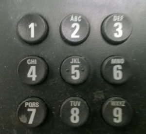 The keypad of a telephone showing the buttons for numbers 1 to 9