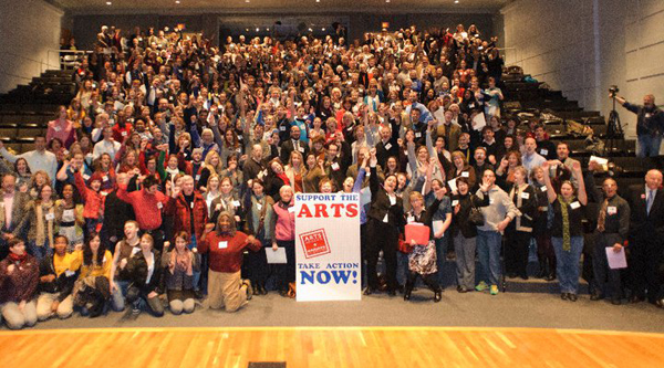 A crwod of people gathered in an auditorium to advocate for the arts