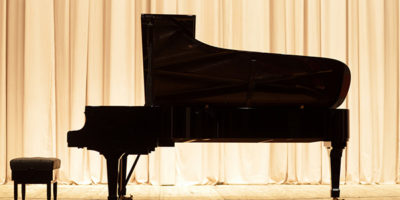 The piano on the brown curtain background