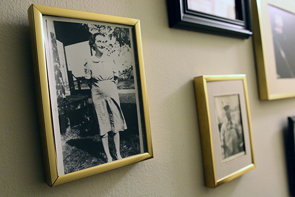 A wall with old portrait photographs in frames