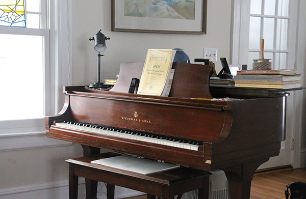 A Schirmer score of Bach's Well Tempered Clavier sits atop a Steinway baby grand piano.