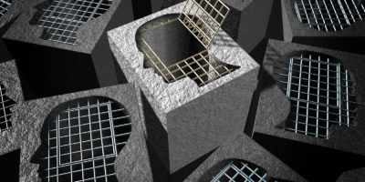 Independent thinking and open mind concept as a freedom metaphor for an innovative thinker as a cement prison with open metal jail bars shaped as a human head.