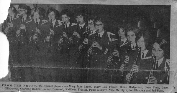 A reproduction of photo from a newspaper of 12 uniformed young people playing clarinets.