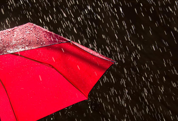 A red umbrella in heavy rain