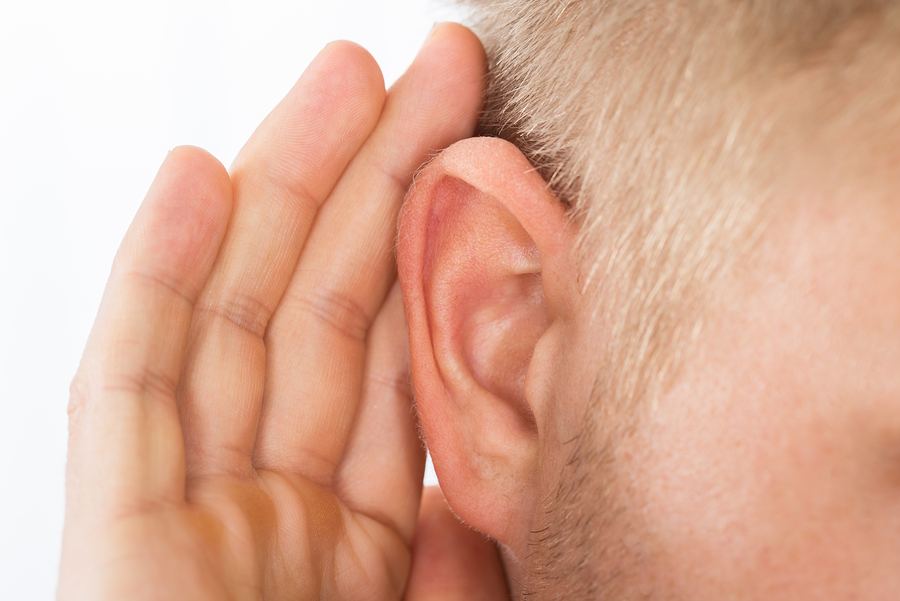 Person Trying To Hear With Hand Over Ear