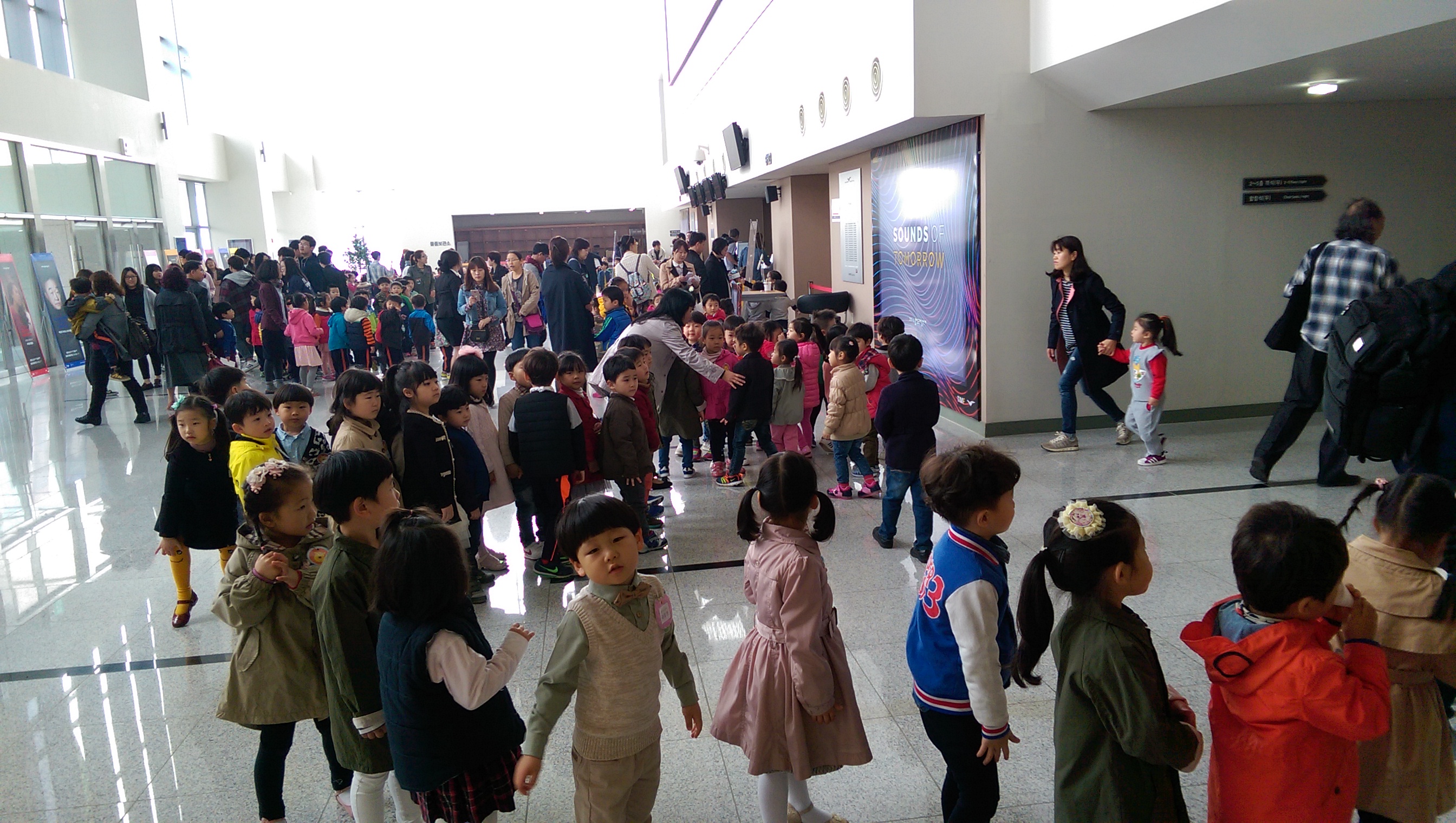 Korean children lining up inside the lobby of the TIMF Concert Hall.