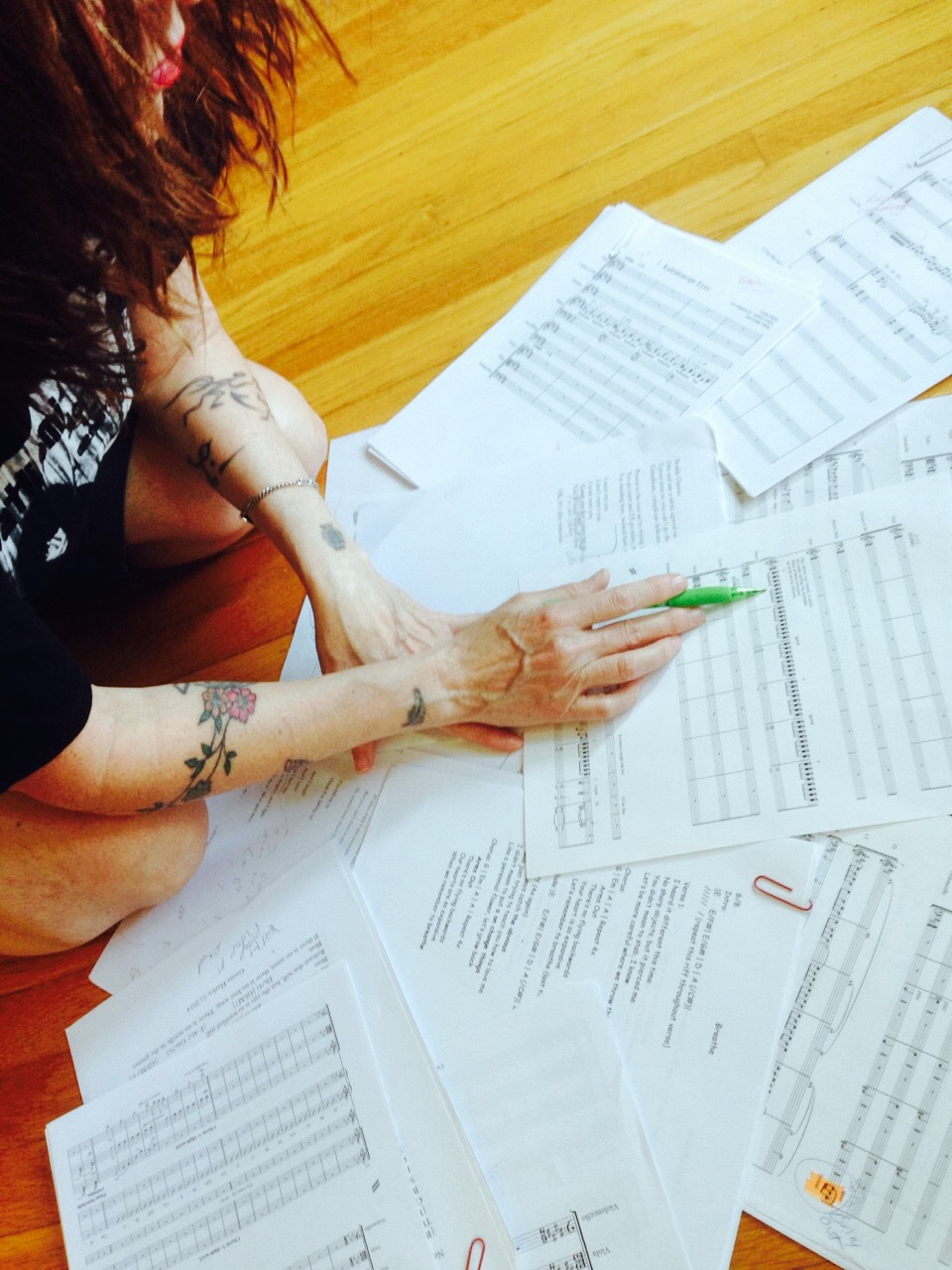 Photo by Angela Castañeda of Gretta with a group of scores and leadsheets.