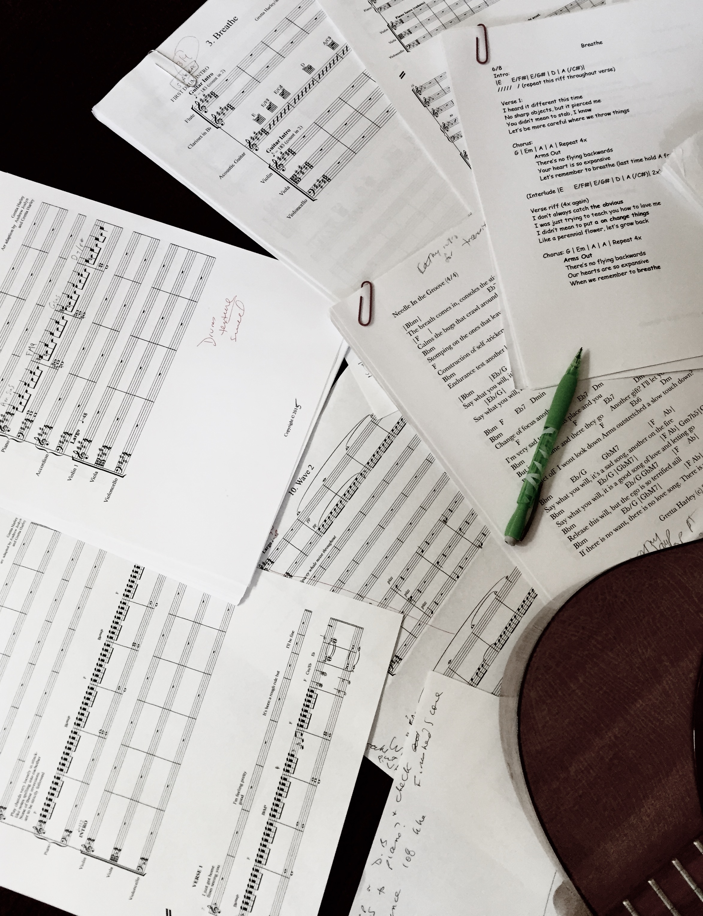 Photo by Angela Castañeda of a group of scores and leadsheets and a pen.