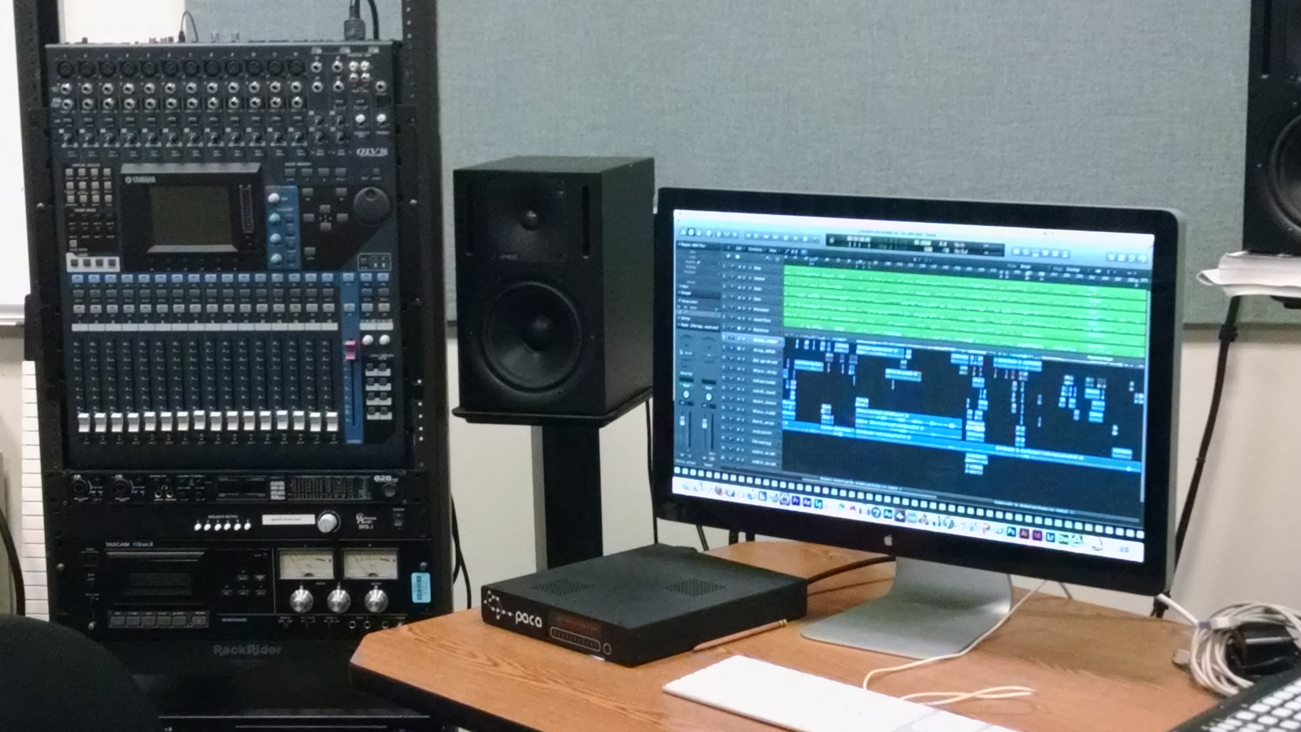 A mixing console, processor, speaker, video screen and other equipment in Eric Chasalow's music studio.