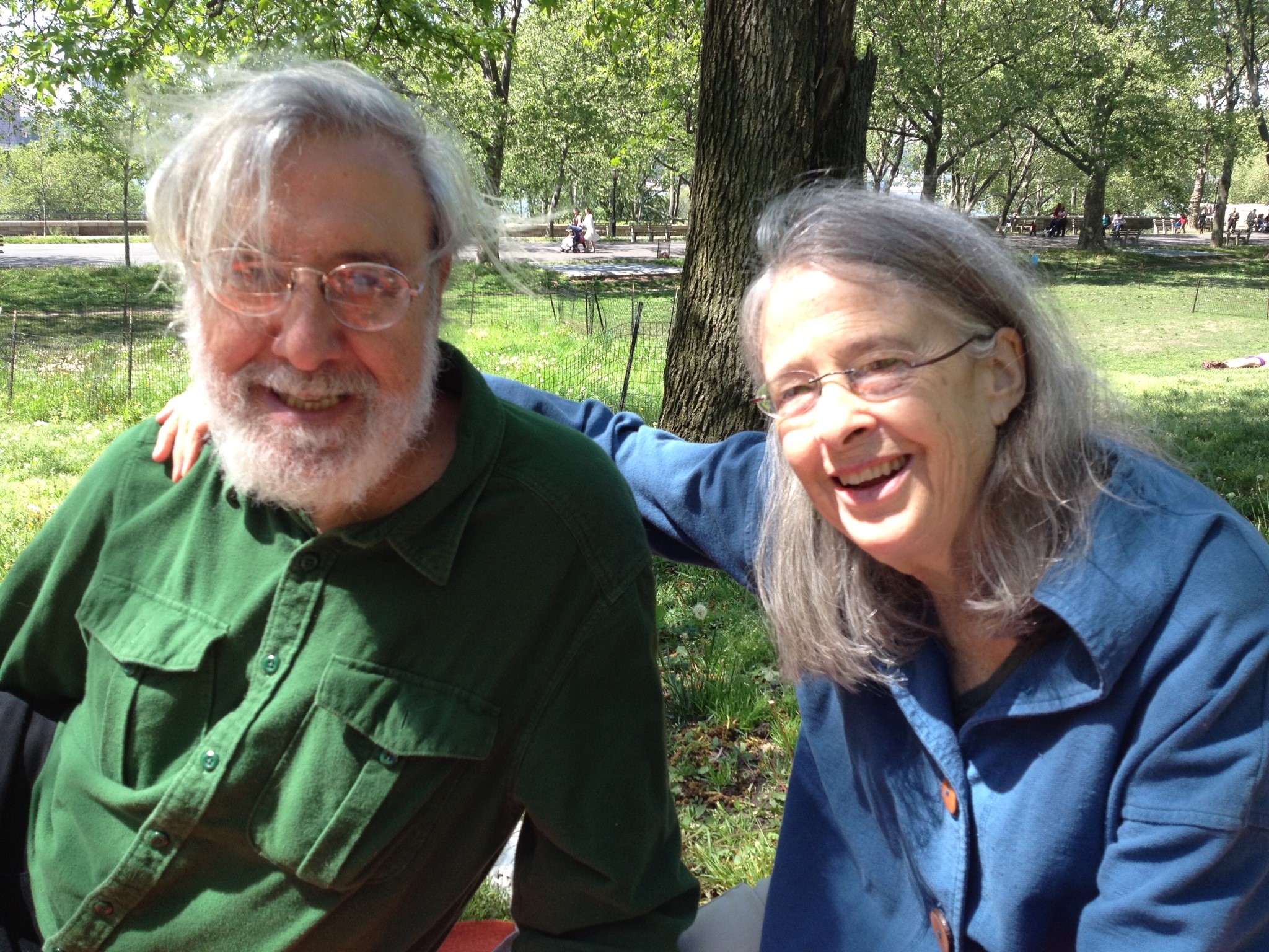 Joel Gressel and Eleanor Cory on a bench in a park.