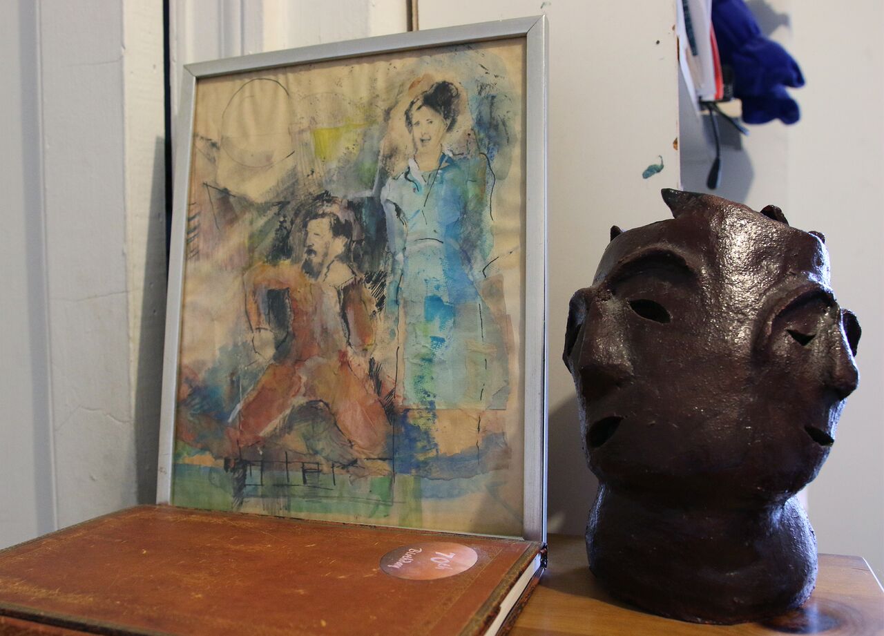 A portrait of Joel Gressel and Eleanor Cory sits next a sculpture in Cory's composition studio.