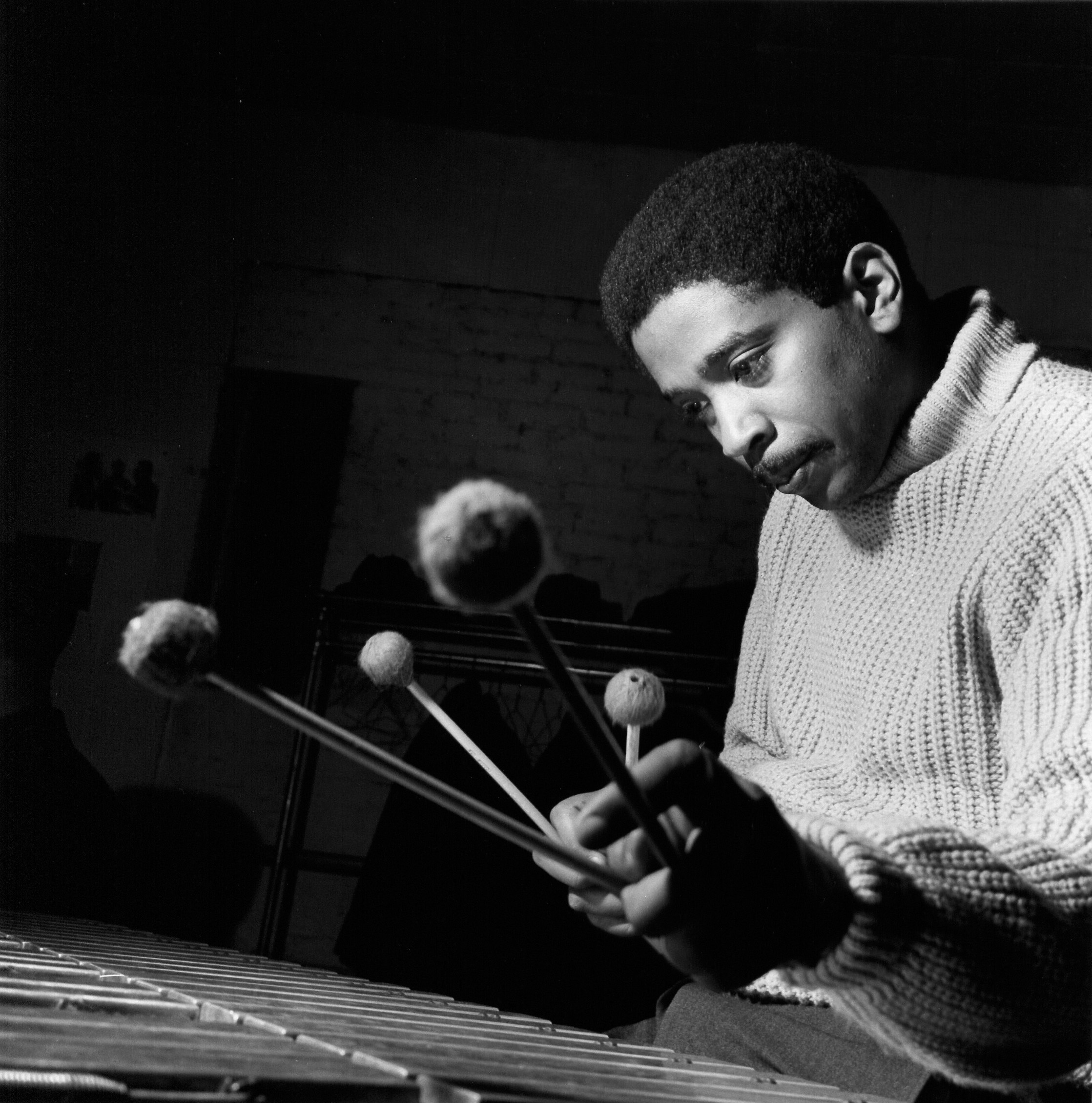 1963 black and white Blue Note Records photo by Francis Wolff of Bobby Hutcherson playing vibraphone during a recording session.
