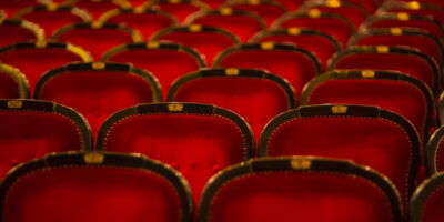 Numbered theater chairs upholstered in burgundy
