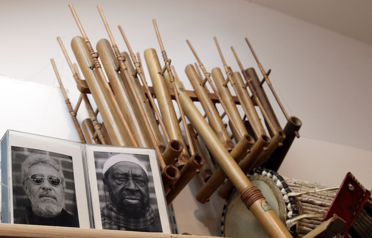 Photos of Adam Rudolph and Yusef Lateef in front of various ethnic percussion instruments.