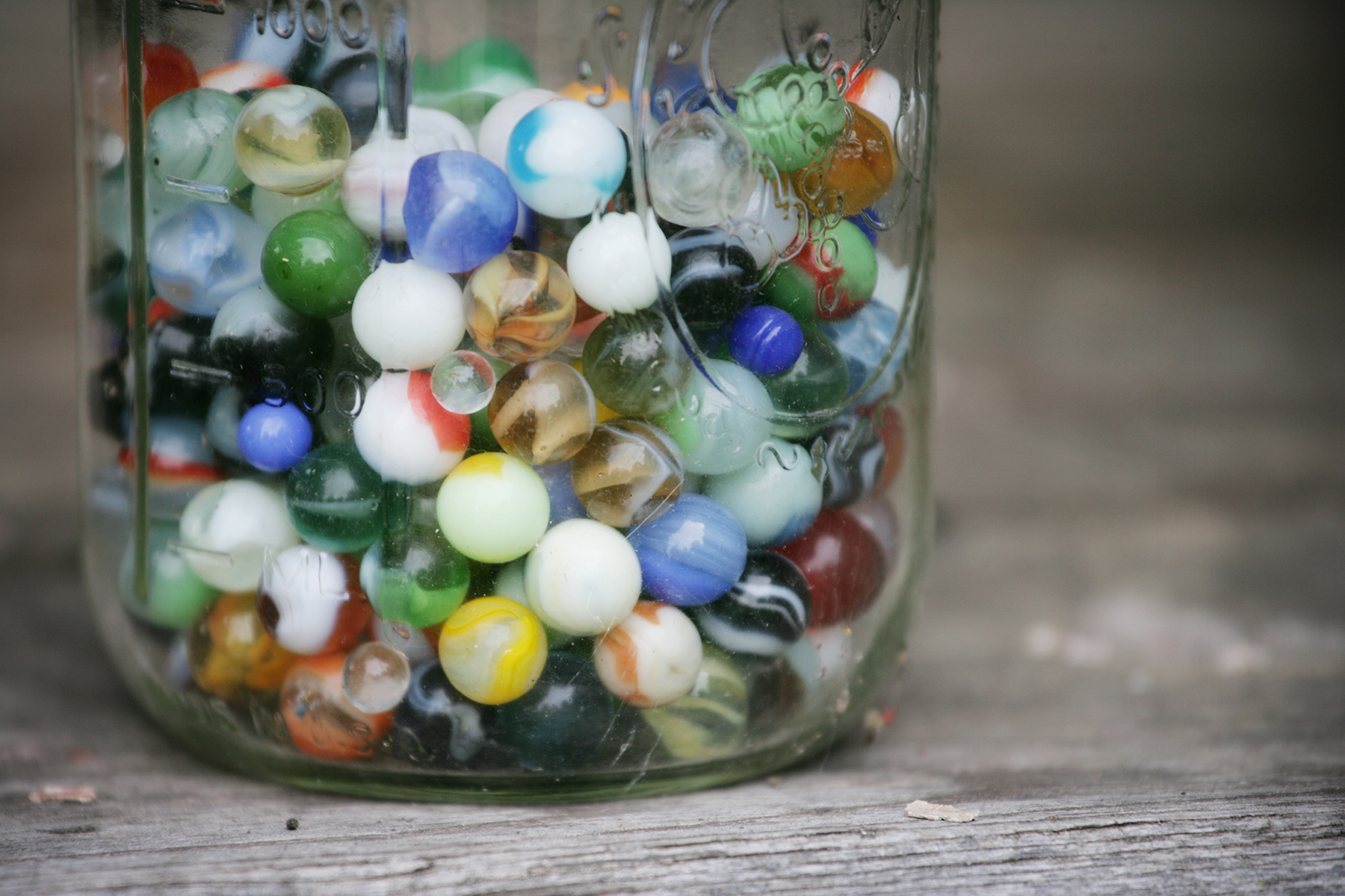 Old Colorful Marbles in a Glass Jar