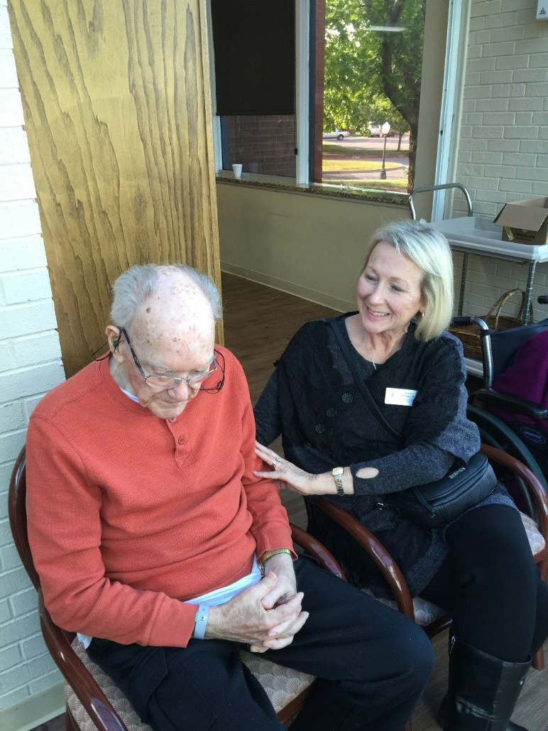Dr. Scherler (right) sitting with a Baptist Village Community Retirement Center resident