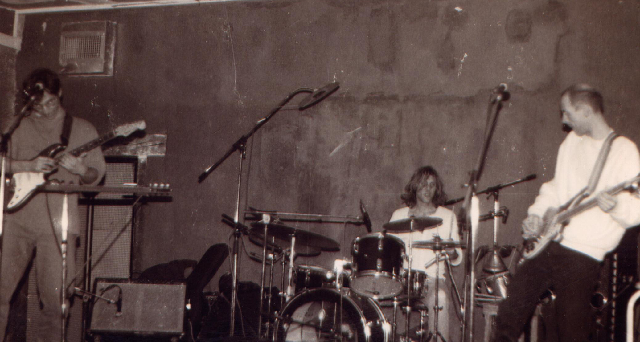 Mike Johnson playing guitar with Dave Kerman on drums and Bob Drake on bass