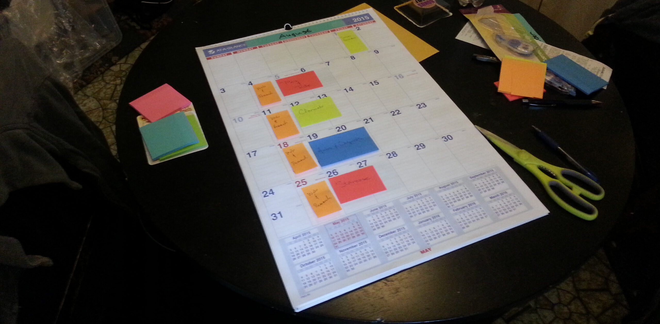 Tobenski's calendar with color coded post-it notes.