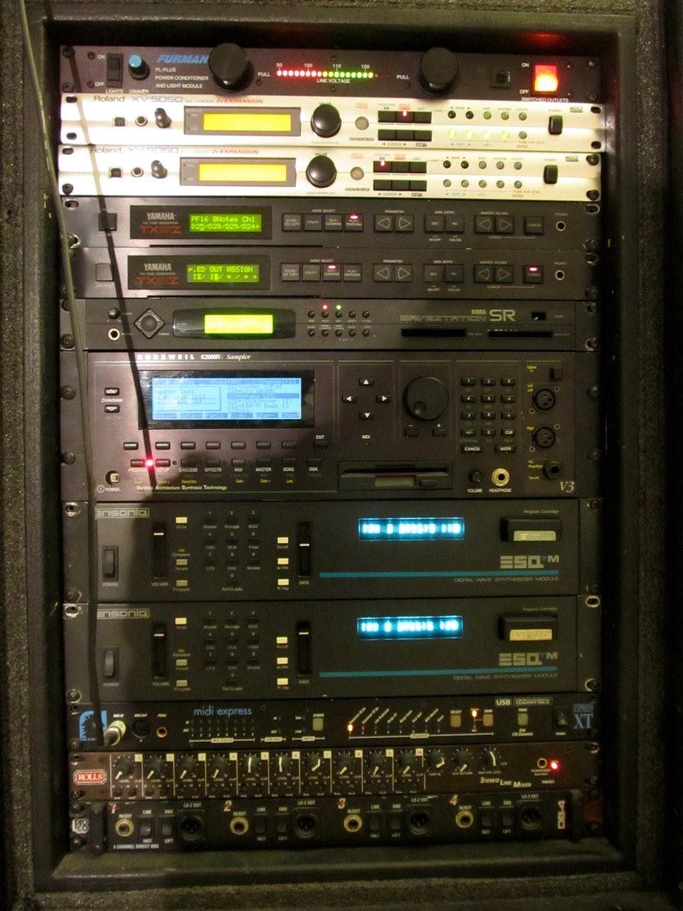 A rack of 1980s hardware synths
