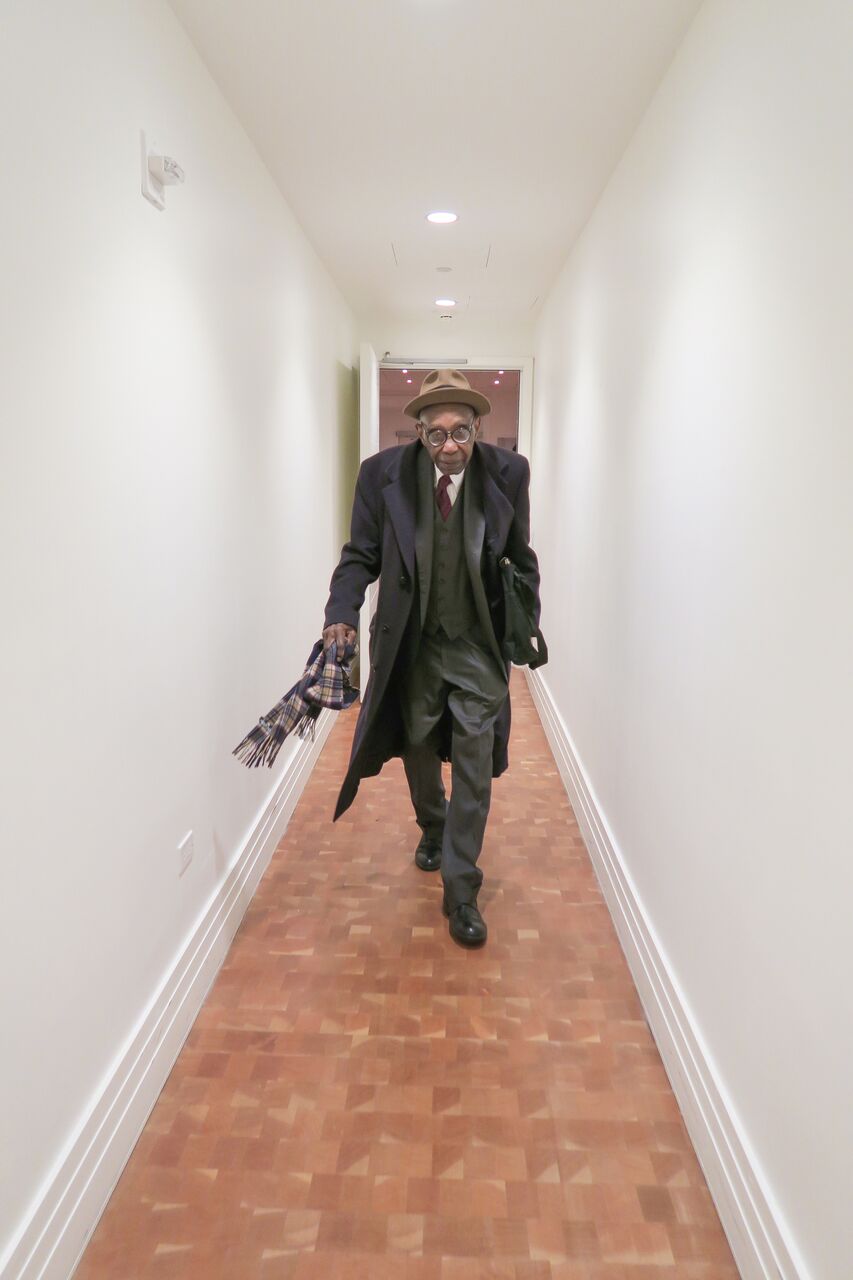 George Walker running down a narrow hallway