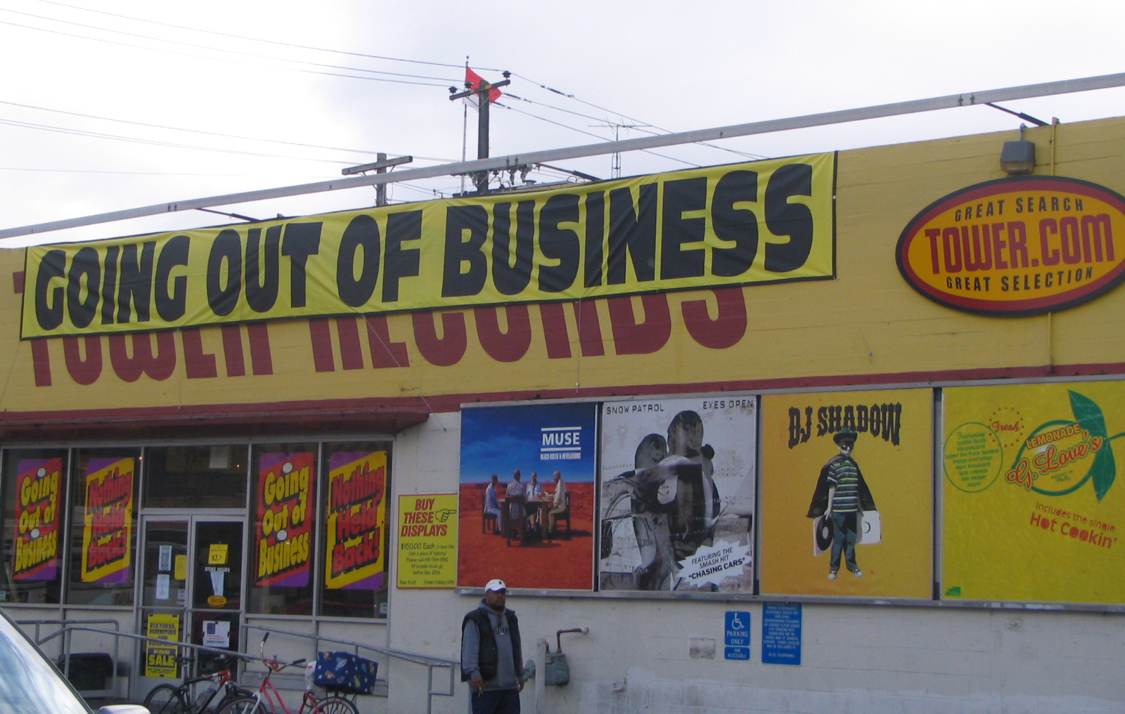 The last days of the San Francisco branch of Tower Records showing the Twoer Records logo on the storefront covered with a "Going Out of Business" banner.
