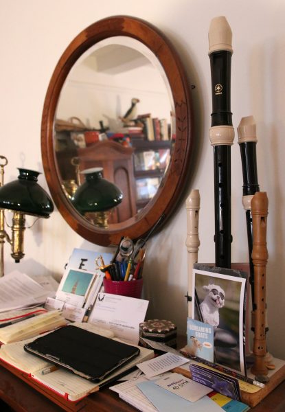 A group of recorders standing on a bureau with a mirror and various personal effects of Beth Anderson.