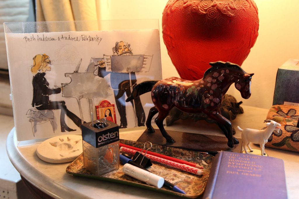 On top of one of her tables, Beth Anderson keeps a drawing of her performing on the piano with flutist Andrew Bolotowski and a couple of toy horses.