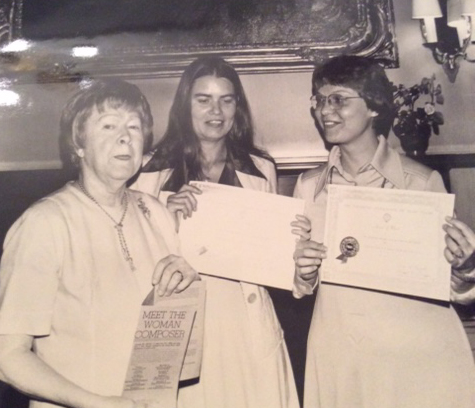 Sorrel Hays (center) and Beth Anderson (right) holding award certificates standing with Julia Smith (left) who is holding a Meet The Woman Composer brochure.