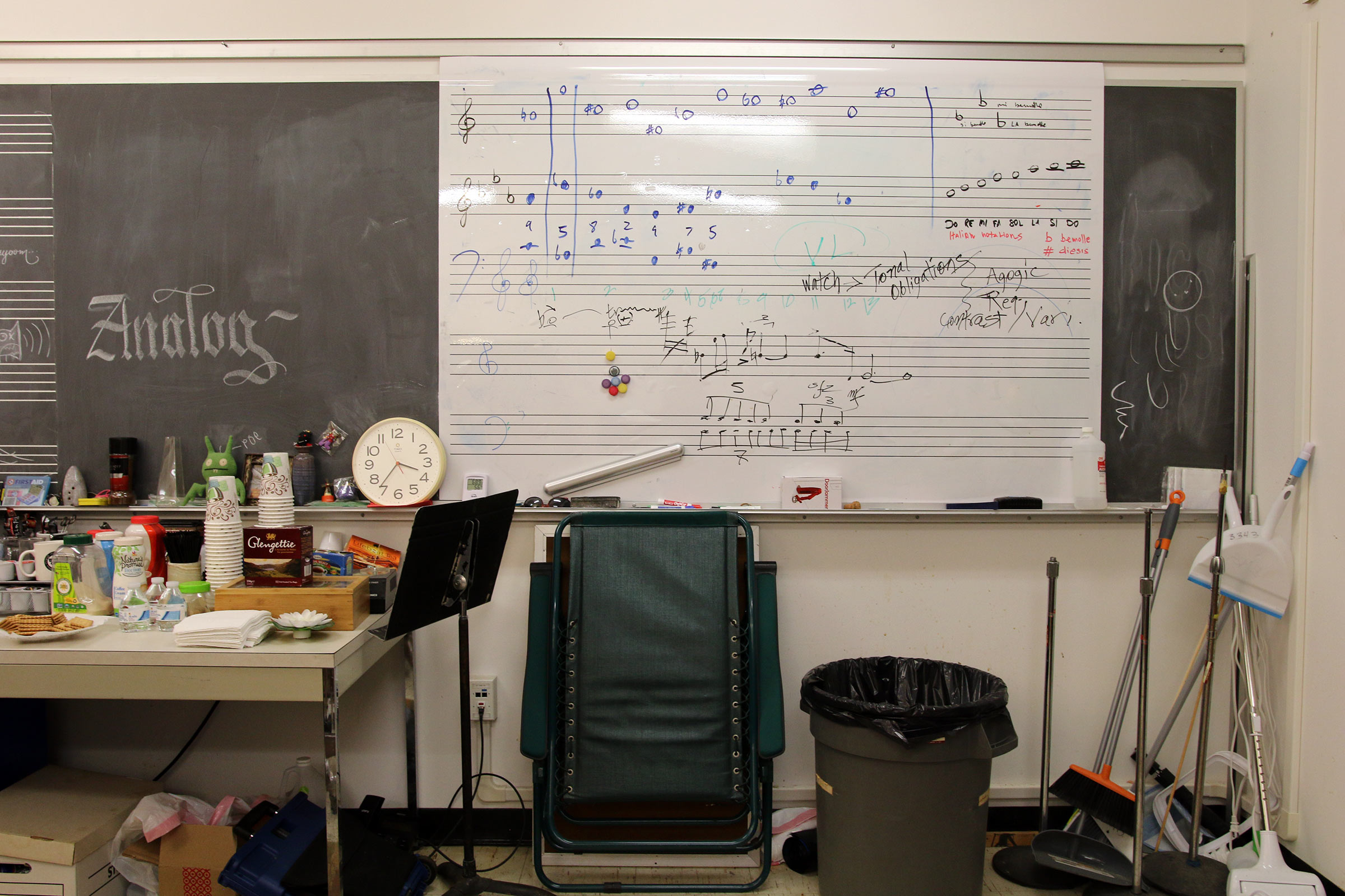 The whiteboard in Daria Semegen's electronic music studio at Stony Brook University which includes the phrase "tonal obligations" as well as a couple of twelve-tone rows and a diatonic scale.