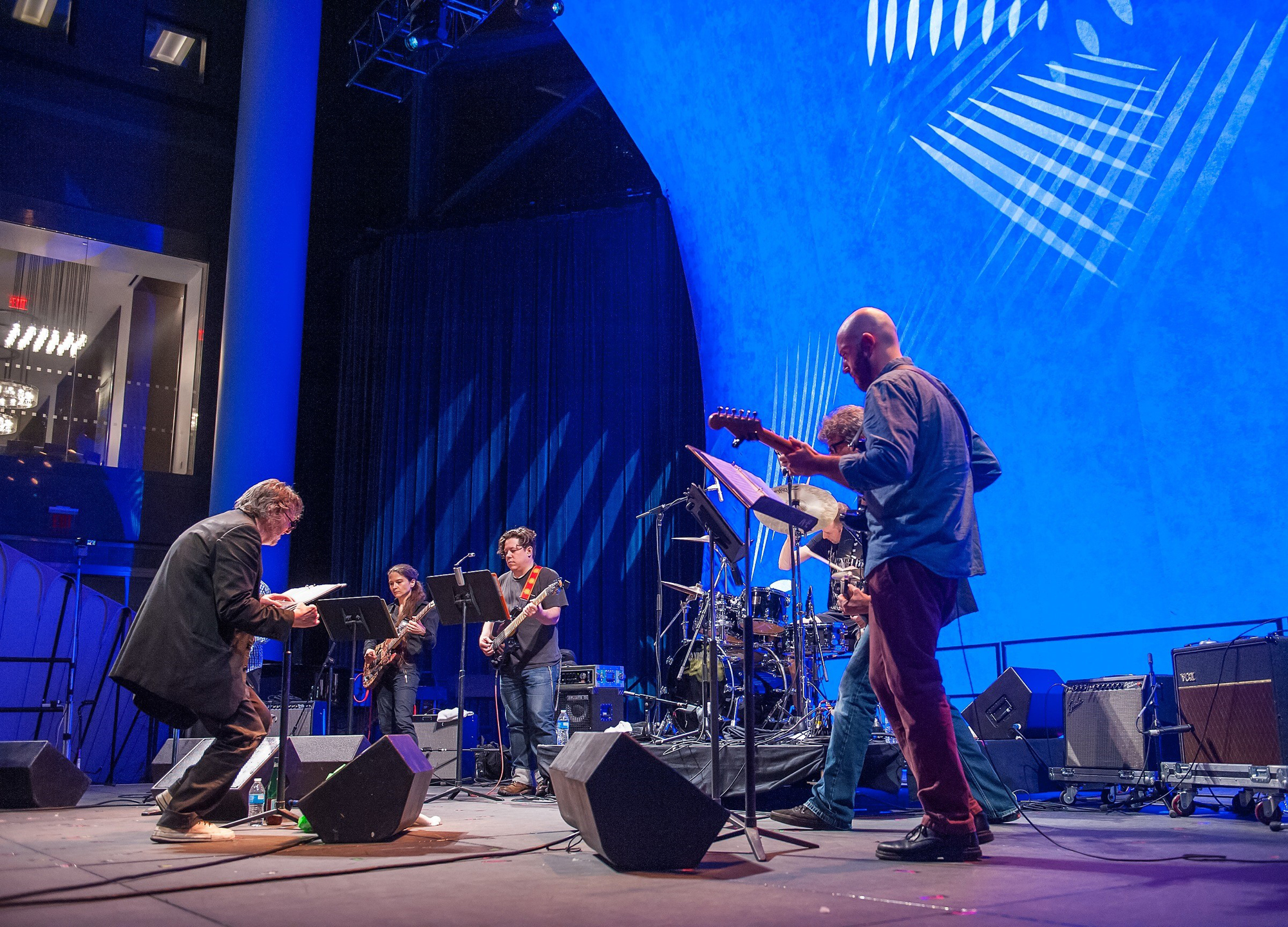 Glenn Branca "conducting" an ensemble of electric guitars in a performance of his Ascension at the World Financial Center's Winter Garden during the 2015 Bang on a Can Marathon (Photo by Stephanie Berger, courtesy Bang on a Can) 