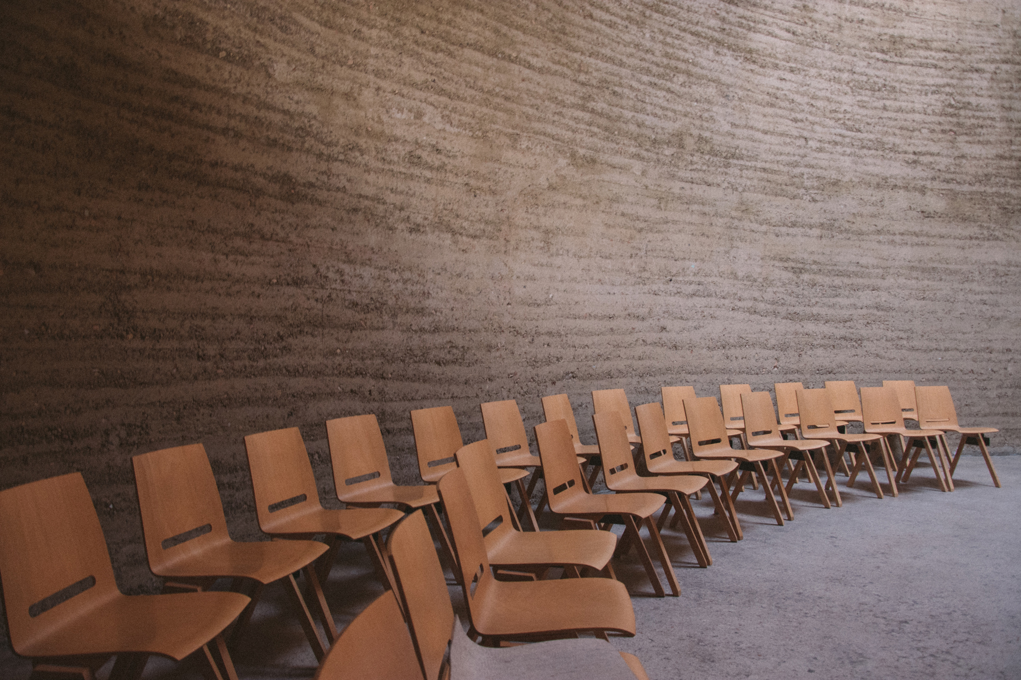 A classroom with two rows of empty chairs. (Photo by Daniil Kuželev)