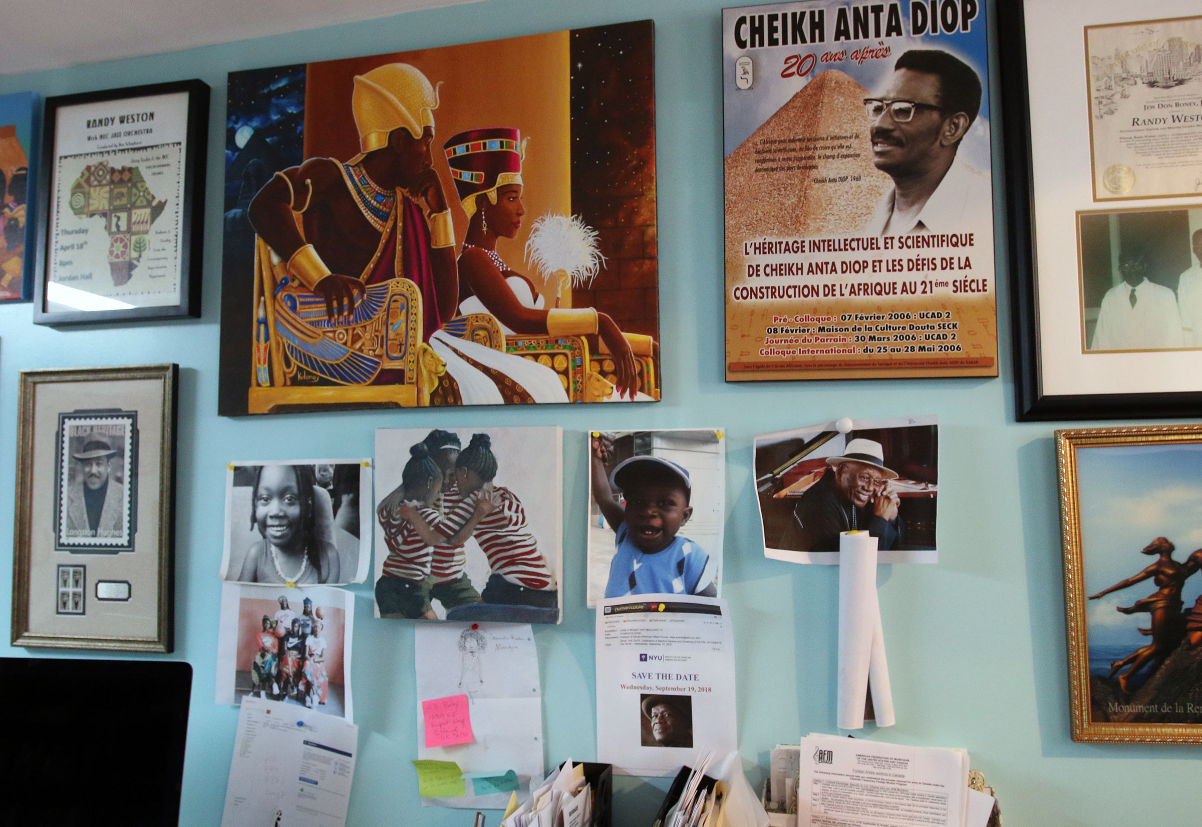 One of the walls in Randy Weston's home which is full of posters and photographs of various African people.