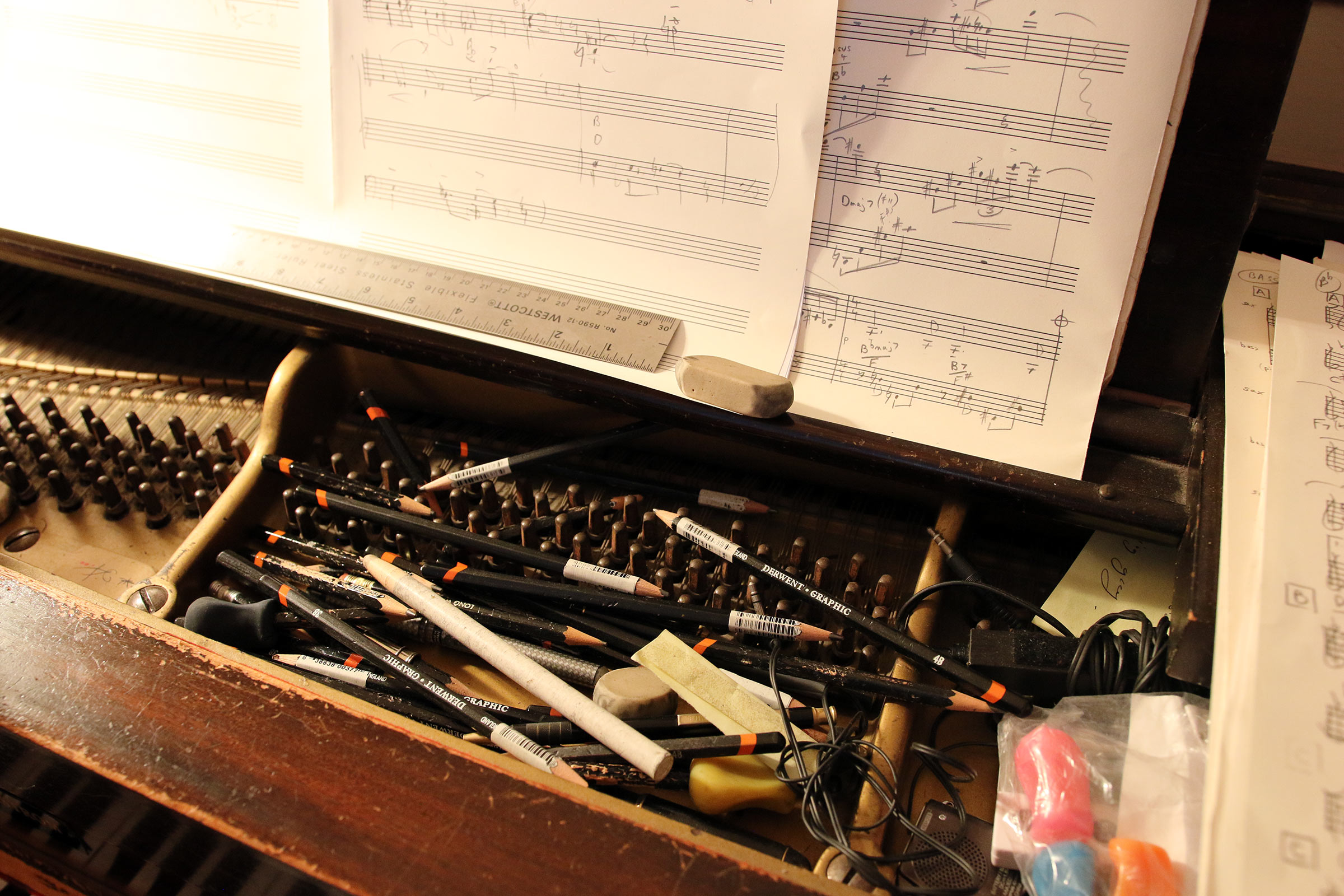The pile of pencils and erasers that Jane Ira Bloom stuffs inside her piano on the frame in front of the strings and some music manuscript paper.