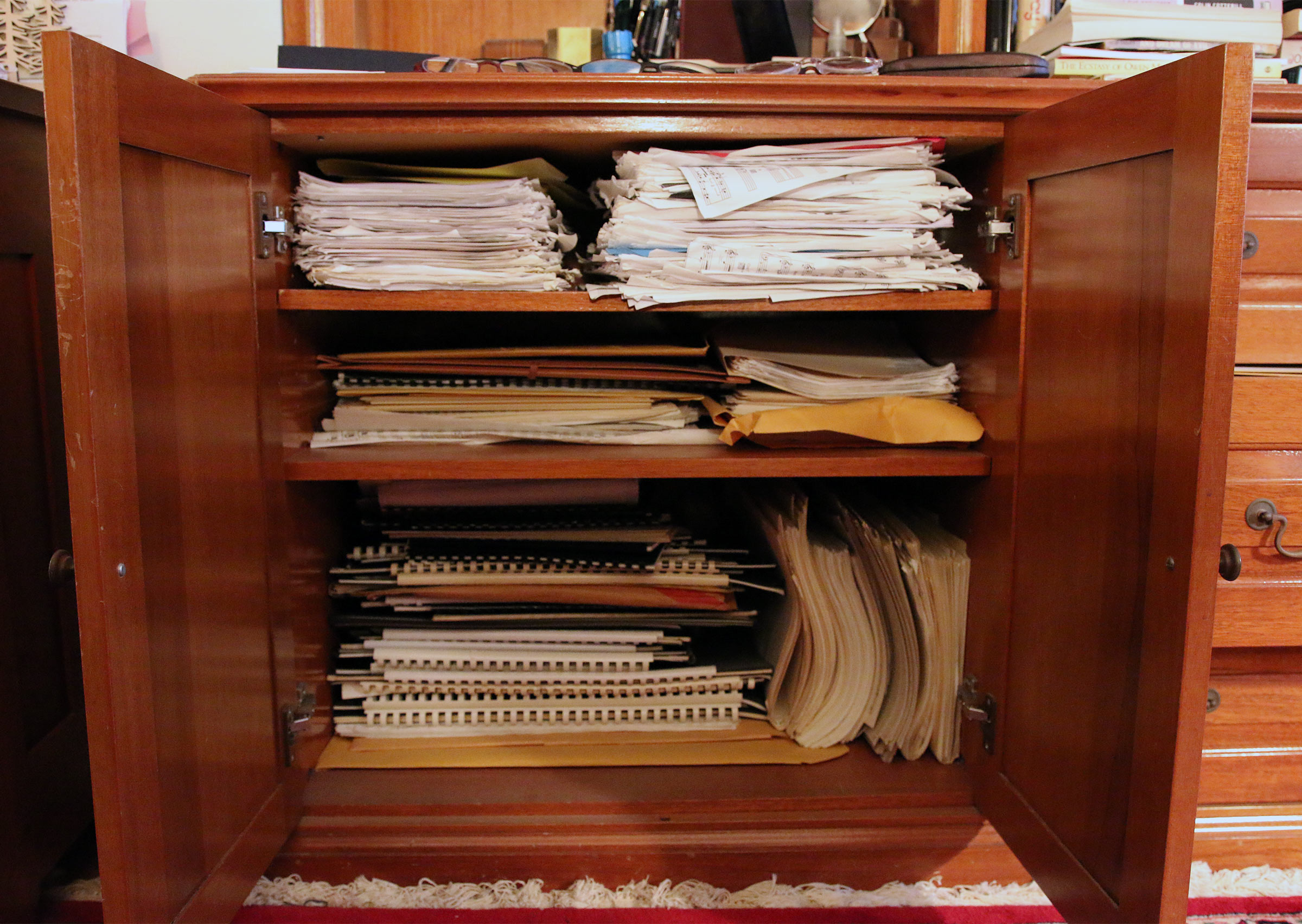 Shelves in Jane Ira Bloom's cabinet filled with her orchestral scores and parts.