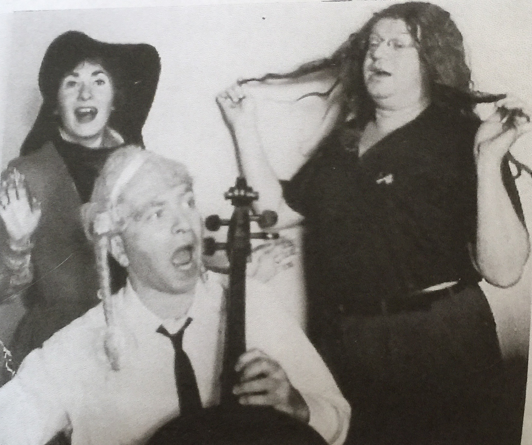 Ben Weber in a wig with Seymour Barab playing a cello and an unidentified woman.