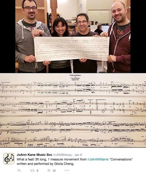 From the Twitter feed of music engraver Joanne Kane showing four people holding John Williams's one-page solo piano score with a closer detail of the score below.