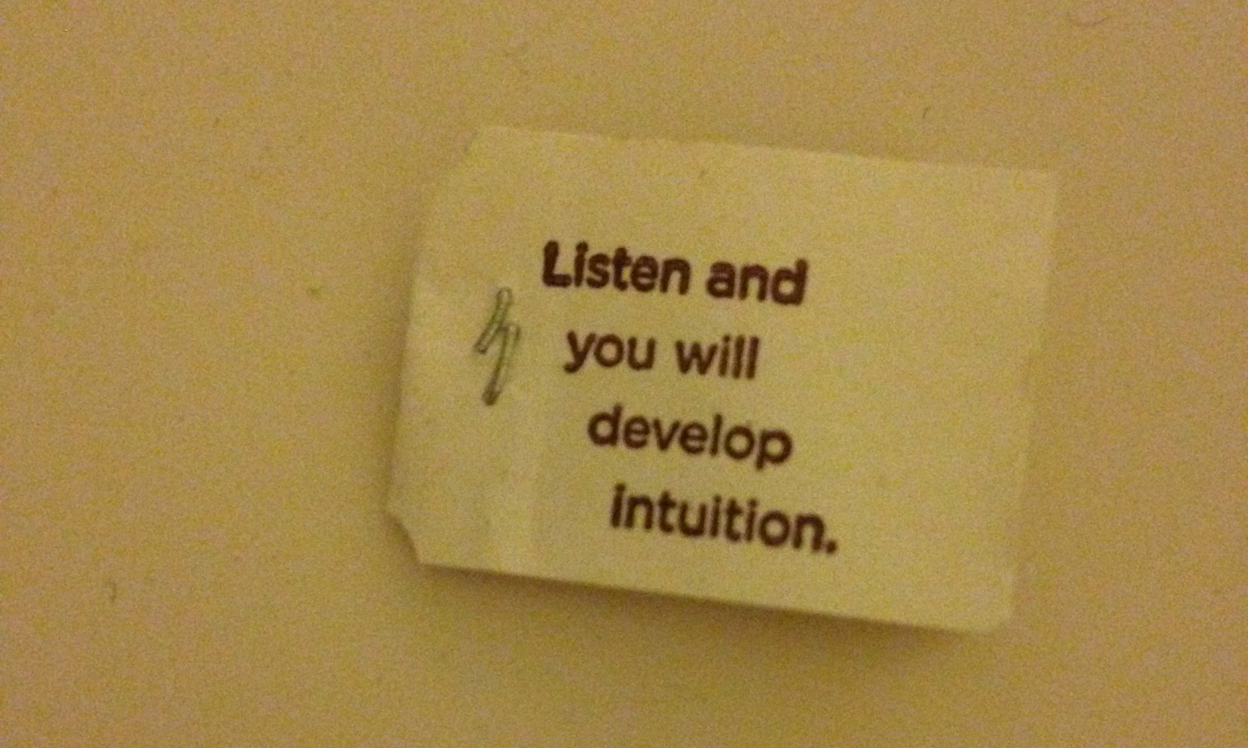 A photo of a tea bag containing the words "Listen and you will develop intuition"