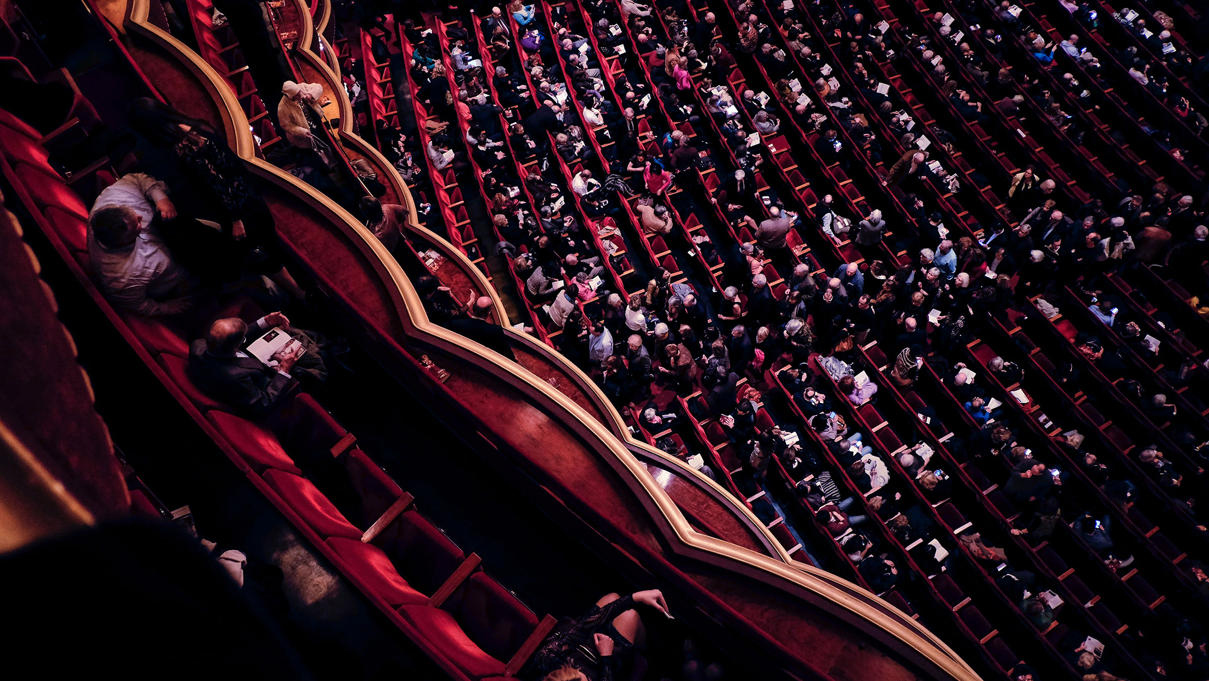 A sideways photo of an audience in a concert hall