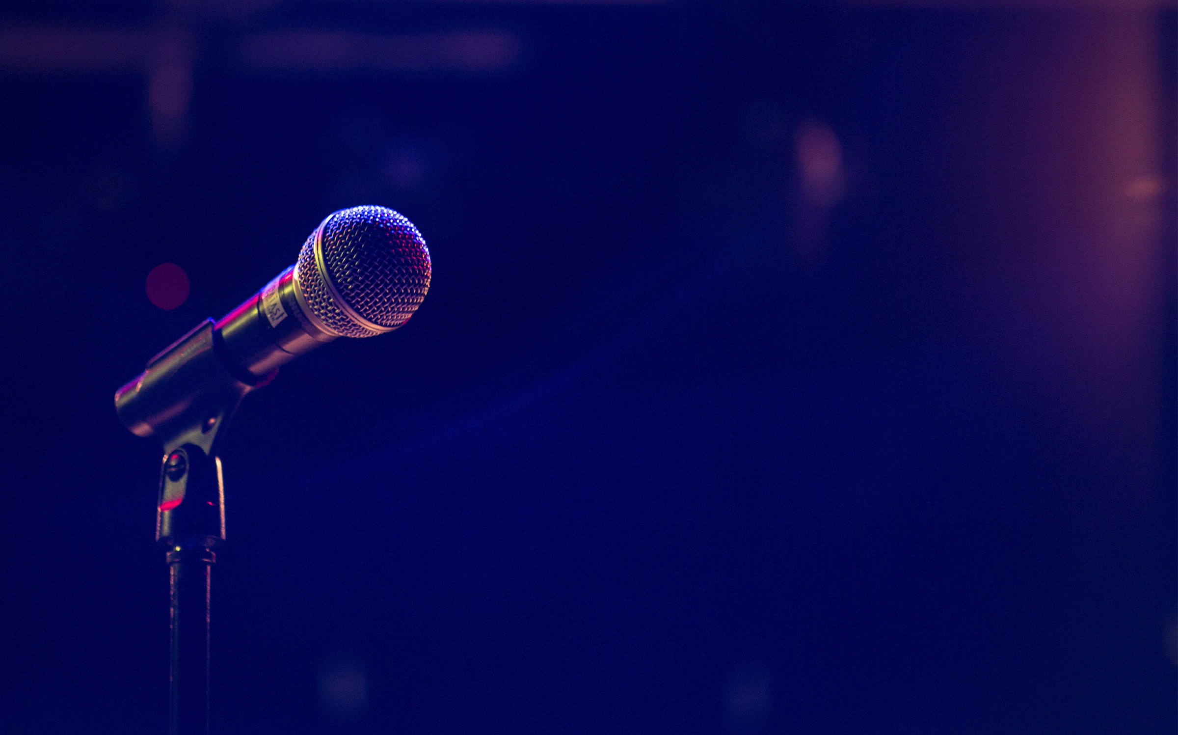 A photo of a microphone with a dark background
