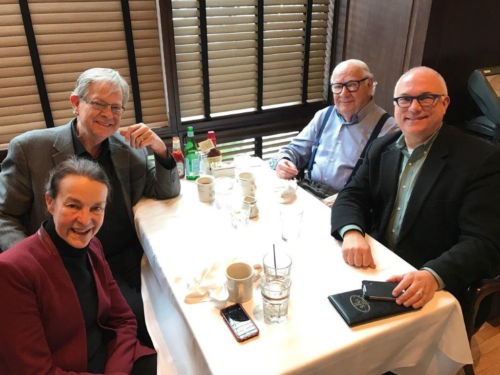 Libby Larsen, Dale Warland, Dominick Argento, and John Neuchterlein seated at a table in a restaurant.