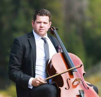 Isaac Brooks in a tie and jacket playing a cello outdoors.