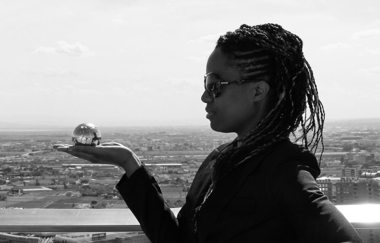 Karlyne Félix holding a glass globe